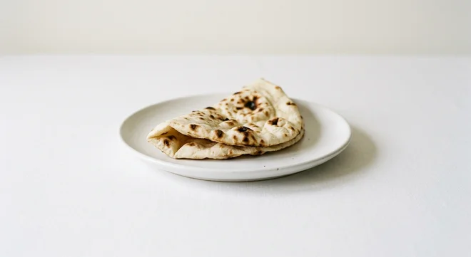 Wetherspoon Plain Naan, folded plain naan bread on a white plate, nutrition and calories