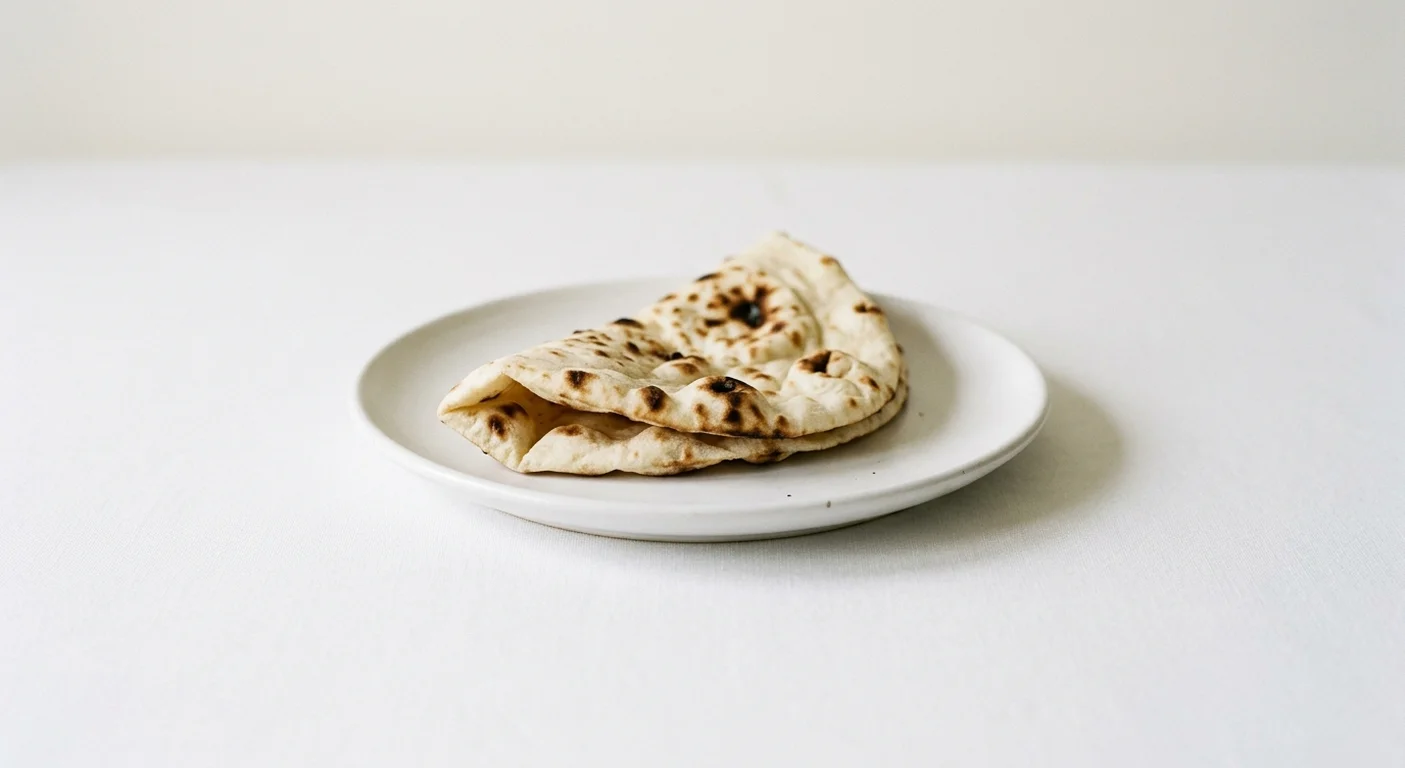 Wetherspoon Plain Naan, folded plain naan bread on a white plate, nutrition and calories