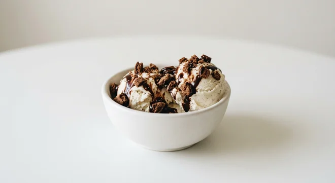 Wetherspoon Cookie Crunch, vanilla ice cream with crushed chocolate biscuit and chocolate sauce in a white bowl, nutrition and calories