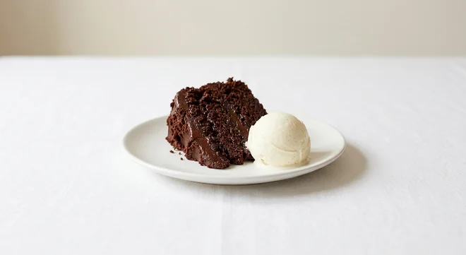 Wetherspoon Warm Chocolate Fudge Cake with Ice Cream, slice of warm chocolate fudge cake with a scoop of vanilla ice cream on a white plate, nutrition and calories