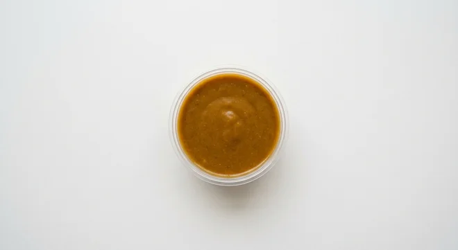 Domino's Katsu Curry Dip, thick golden-brown katsu curry sauce in a takeaway dip pot, nutrition and calories