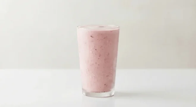 Burger King US Strawberry Shake, a thick pink strawberry milkshake in a tall clear glass, nutrition and calories