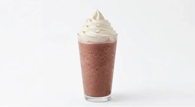 Starbucks US Coffee Frappuccino (Grande), blended coffee drink topped with whipped cream in a clear glass, nutrition and calories