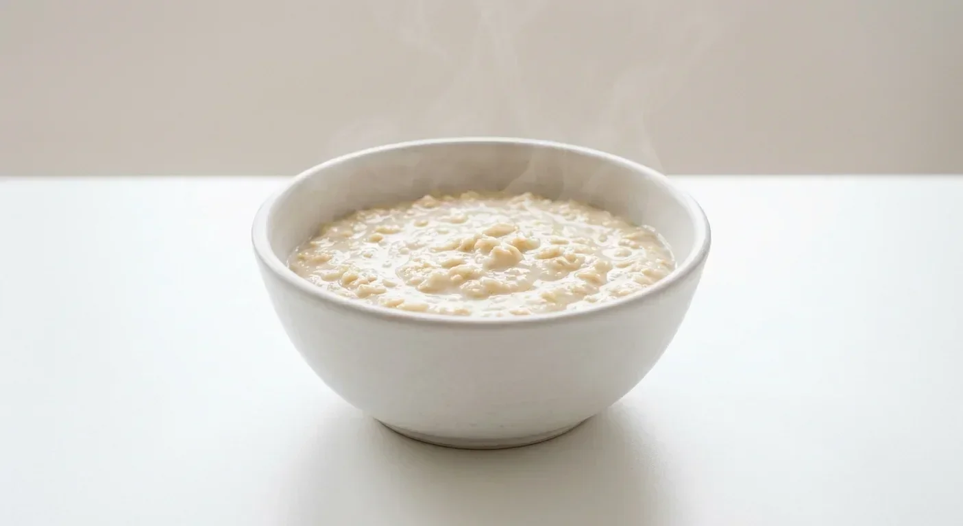Morrisons Porridge Oats, creamy cooked porridge oats in a white bowl with milk, nutrition and calories