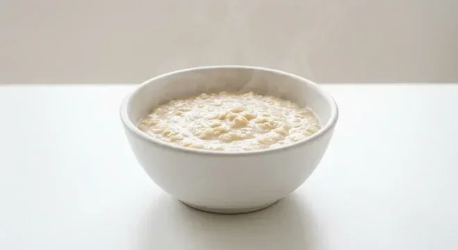 Morrisons Super Smooth Porridge Oats, smooth, creamy cooked porridge in a white bowl with milk, nutrition and calories