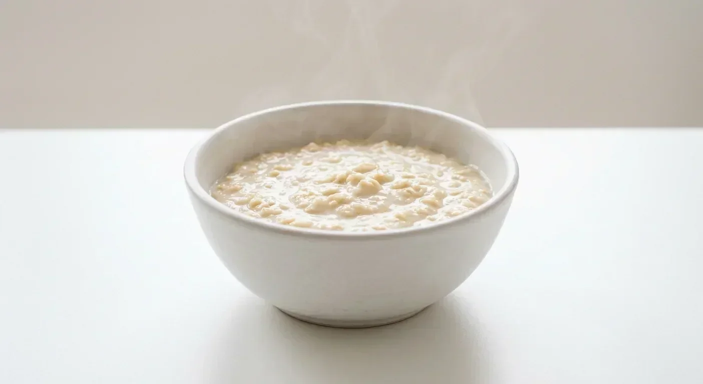 Morrisons Free From Original Porridge Pot, creamy cooked gluten free porridge in a white bowl with milk, nutrition and calories