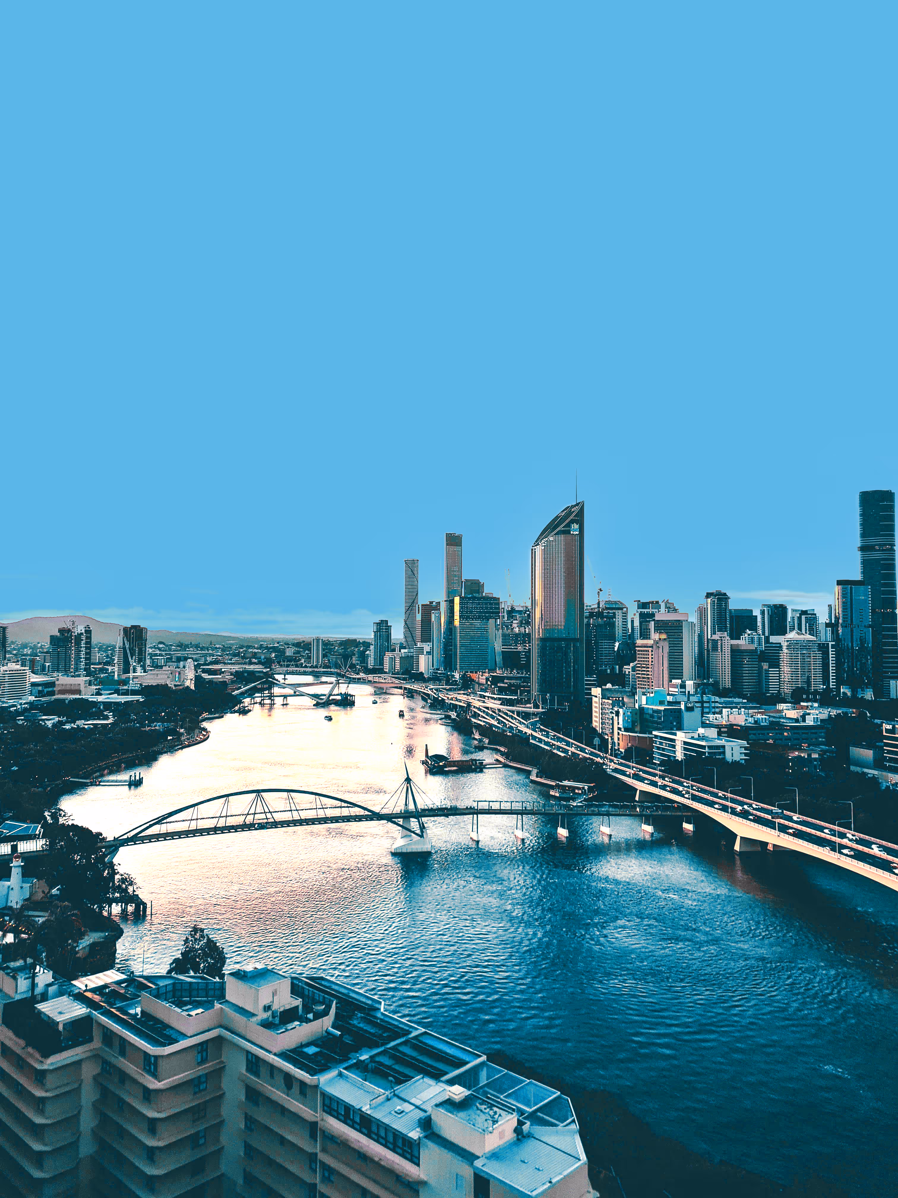 Black and white city skyline featuring tall office buildings and a distant Ferris wheel at dusk.