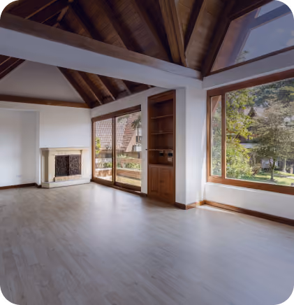 Empty room with wooden ceiling, large windows, glass door, light floor, and a corner fireplace.
