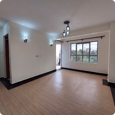 Empty room with wood flooring, a large window, ceiling light fixture, and wall sconces.