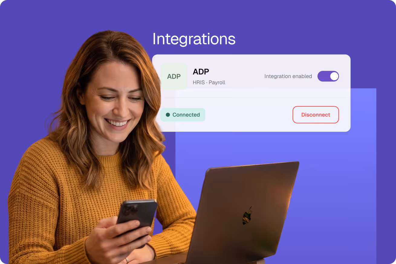 Woman in mustard sweater using smartphone and laptop with an on-screen interface showing ADP integration enabled and connected.