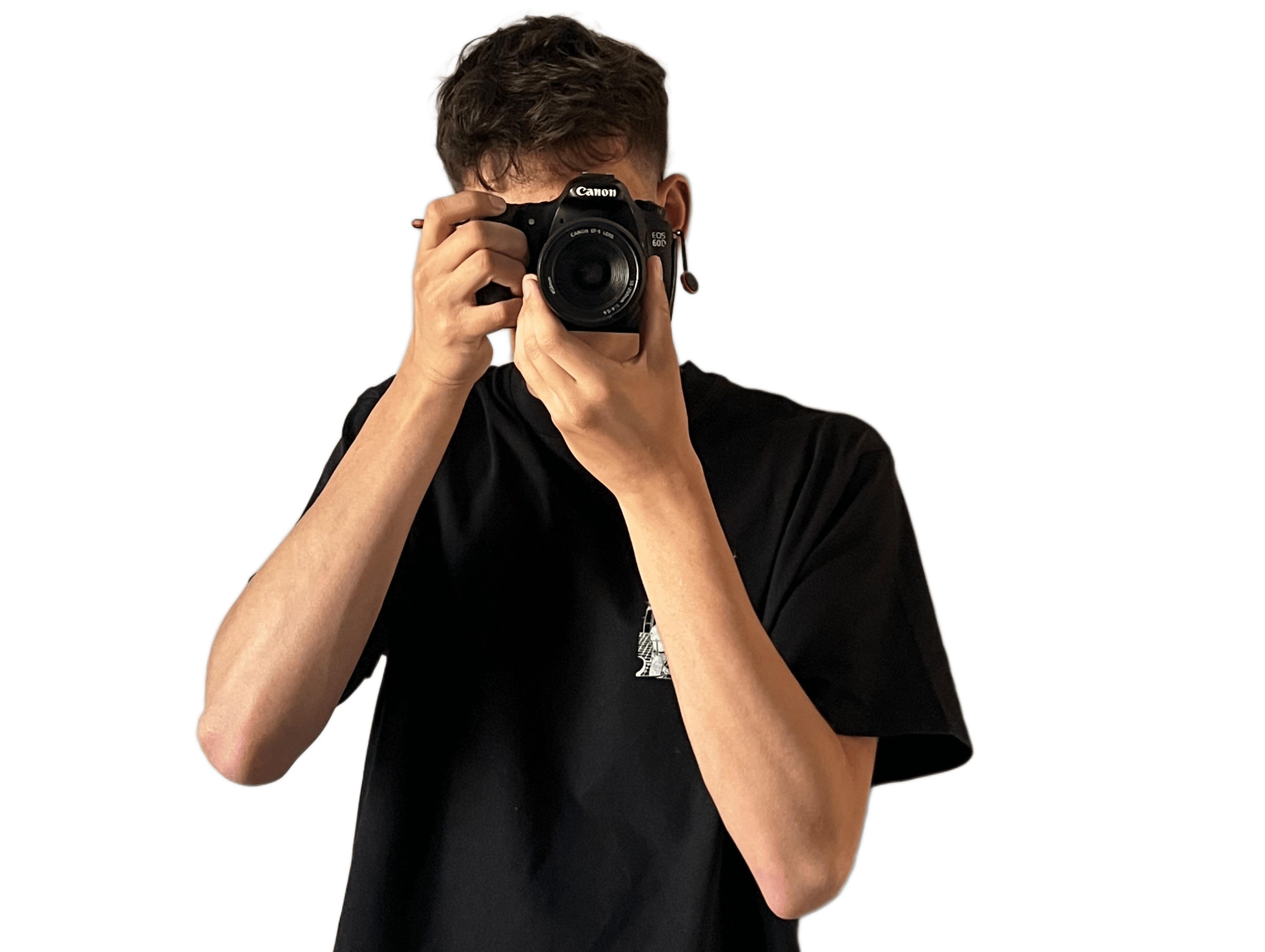 Person wearing black clothing holding a Sony camera with a large lens and showing tattoos on their forearm.