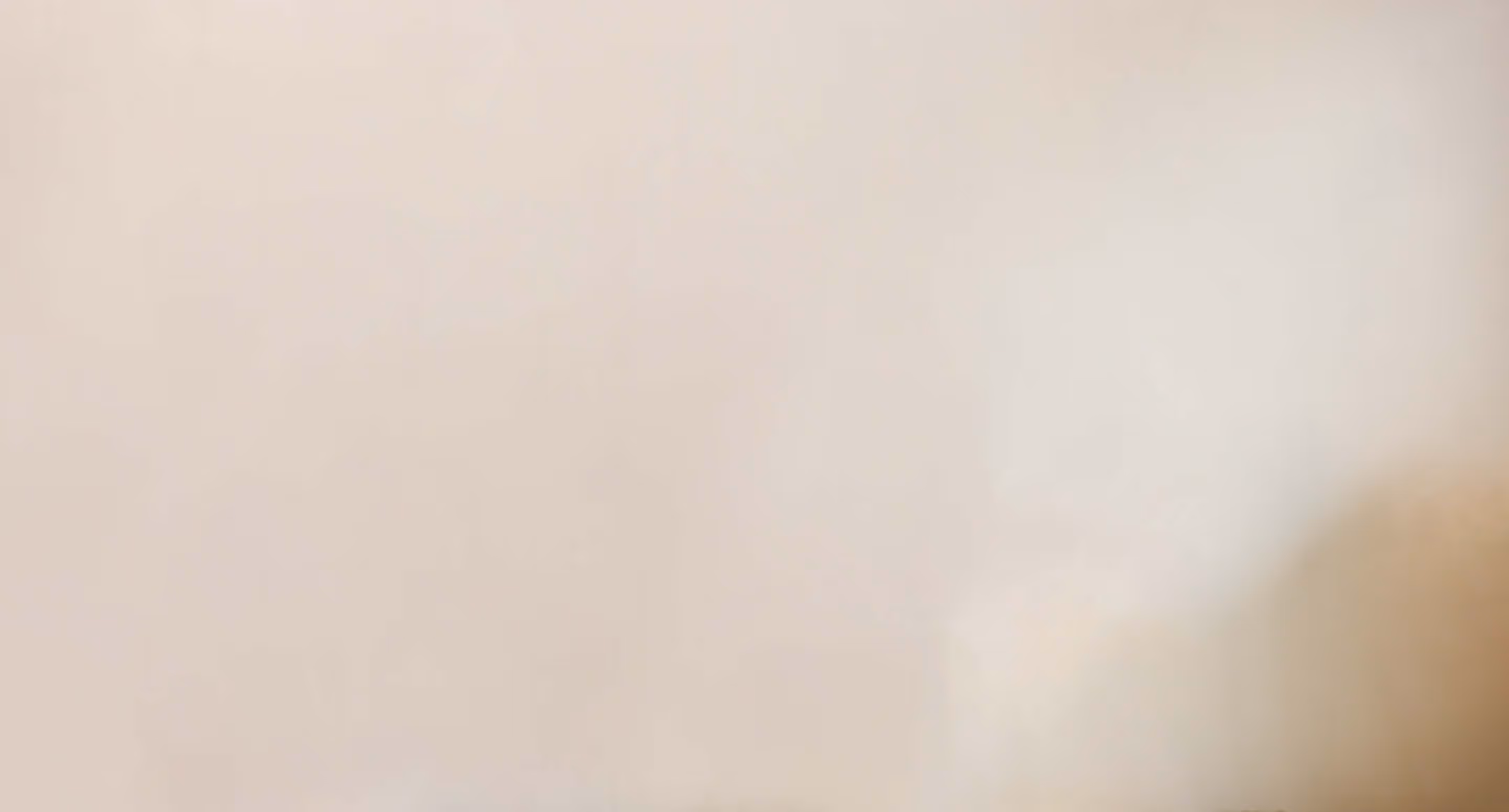 A bare photo of a beige wall.