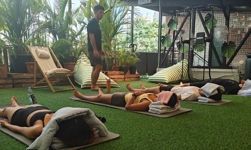 Guided group relaxation session on The Contrast Garden's rooftop lawn