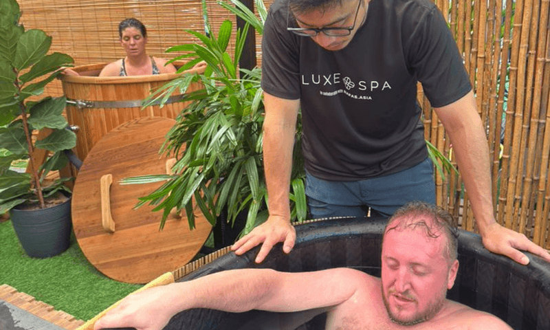A guest being coached through their first cold plunge at The Contrast Garden