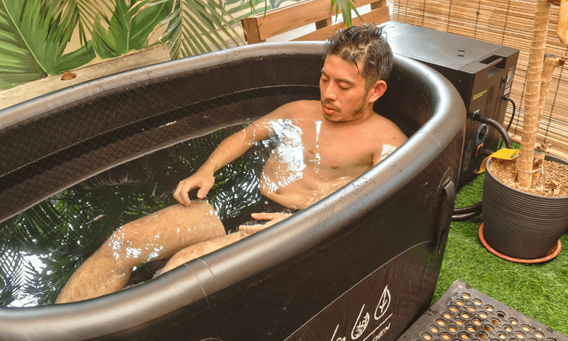 Guest focused on his breathing during a cold plunge at The Contrast Garden