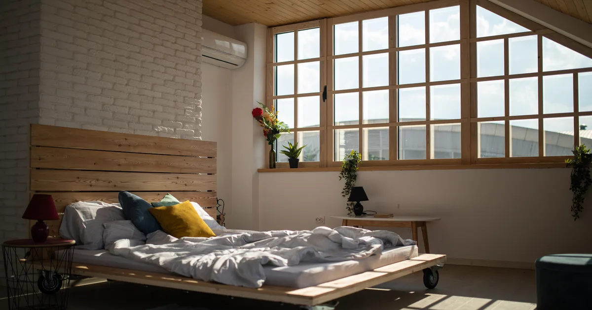 Unmade bed in soft morning light