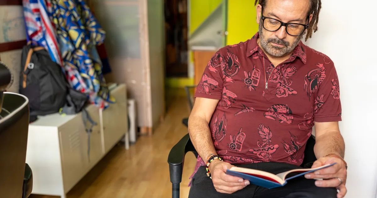 Man reading in a barber shop