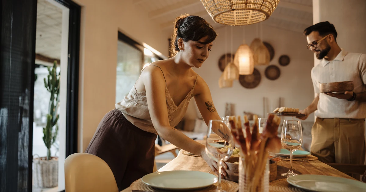 Couple setting a dinner table together