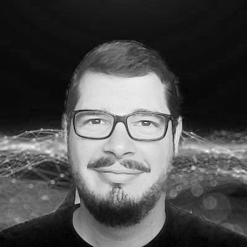 Smiling man with glasses, beard, and mustache with a digital abstract background.