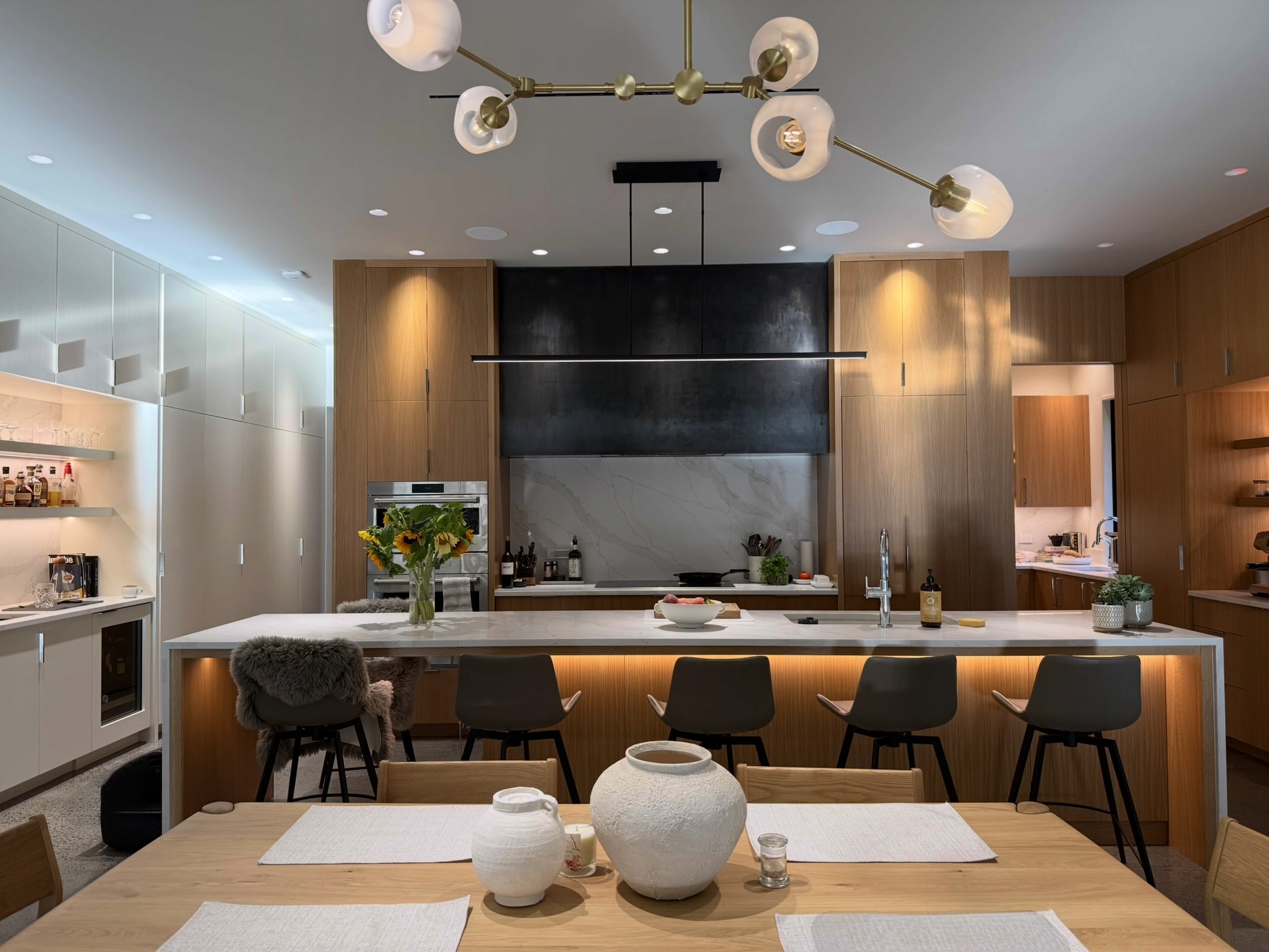 A kitchen with intelligent lighting, Ketra color changing down lights.
