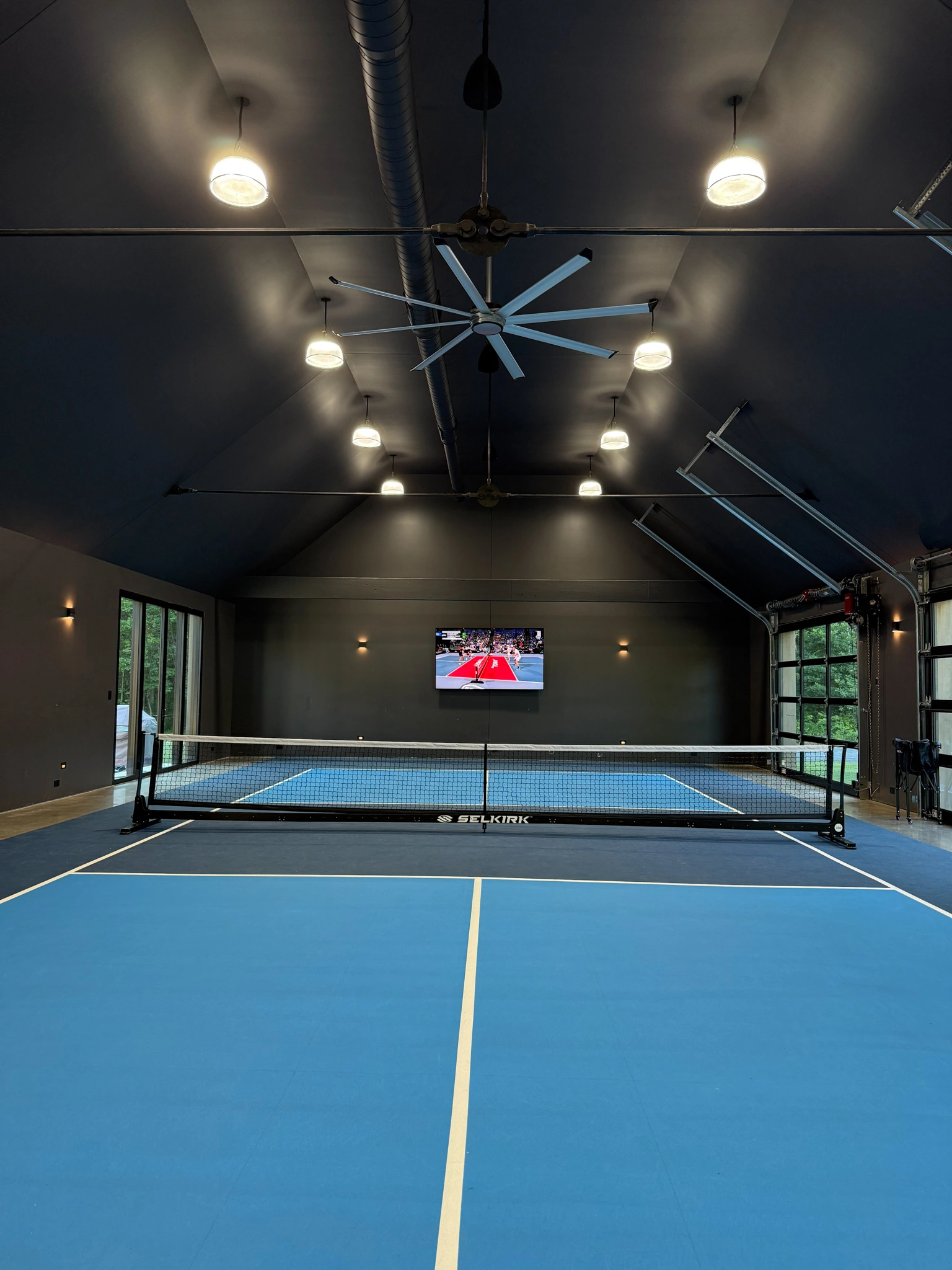 Luxury indoor pickle ball court with intelligent lighting and climate control