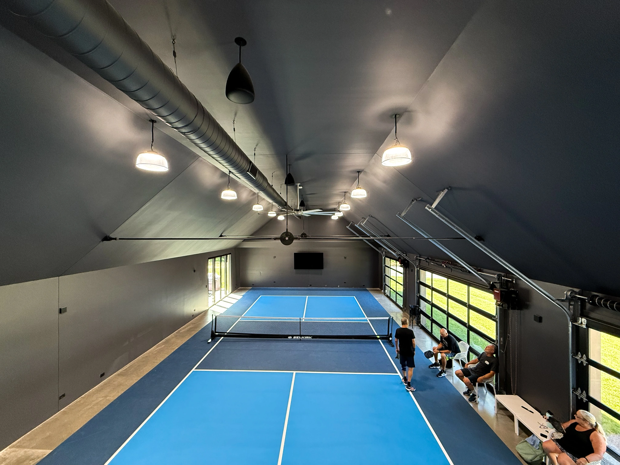 Luxury indoor pickle ball court with intelligent lighting and climate control