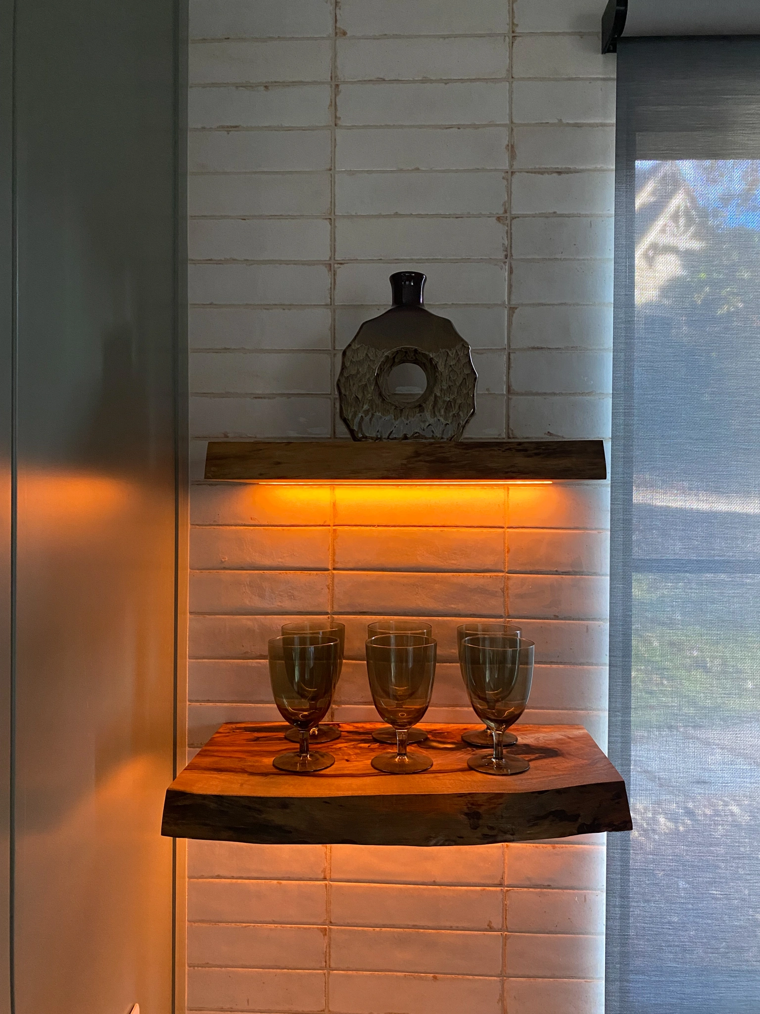 Modern kitchen featuring automated intelligent lighting with Lutron light strips