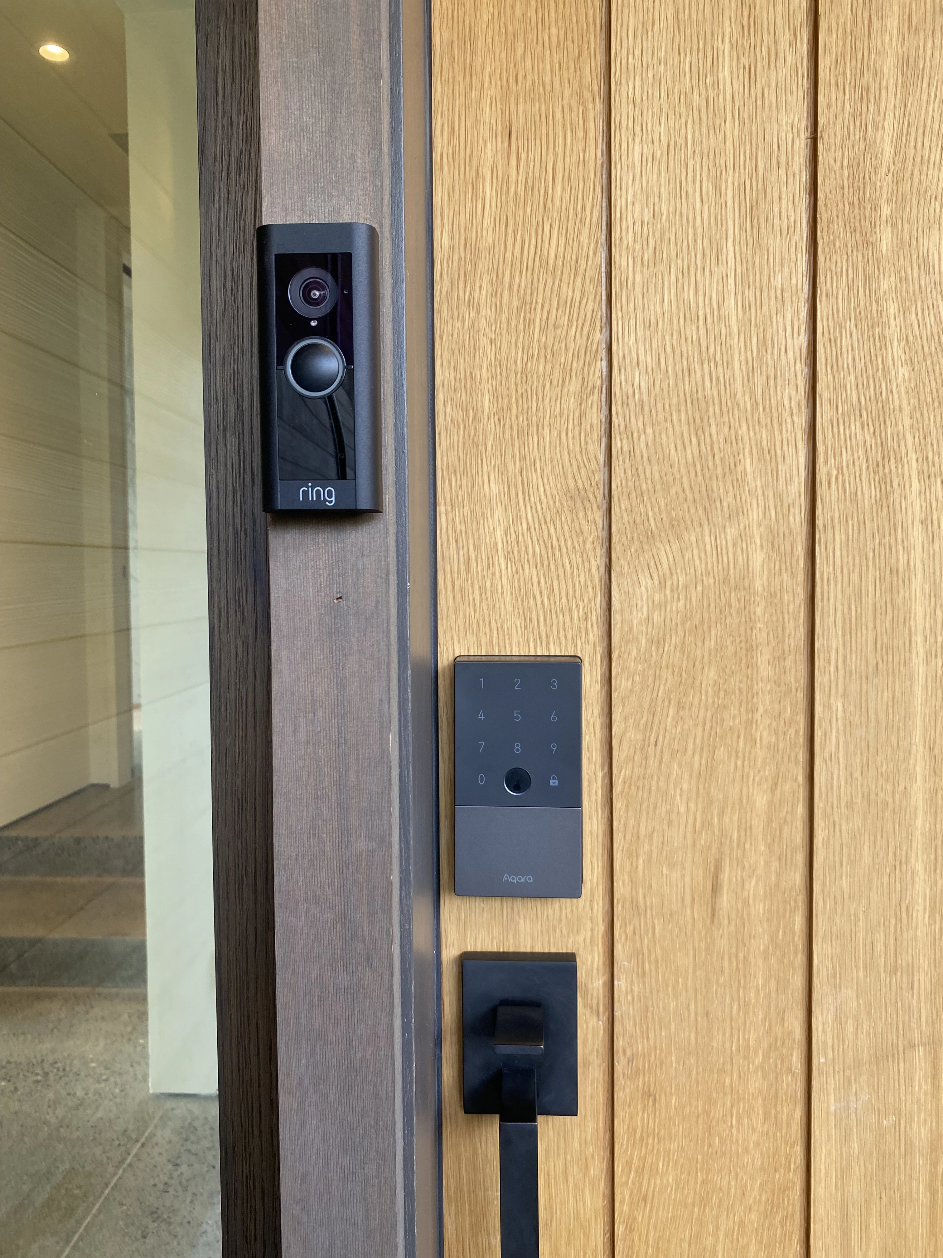 image of a ring doorbell and keypad system installed on an entry door, security installed by iquarters