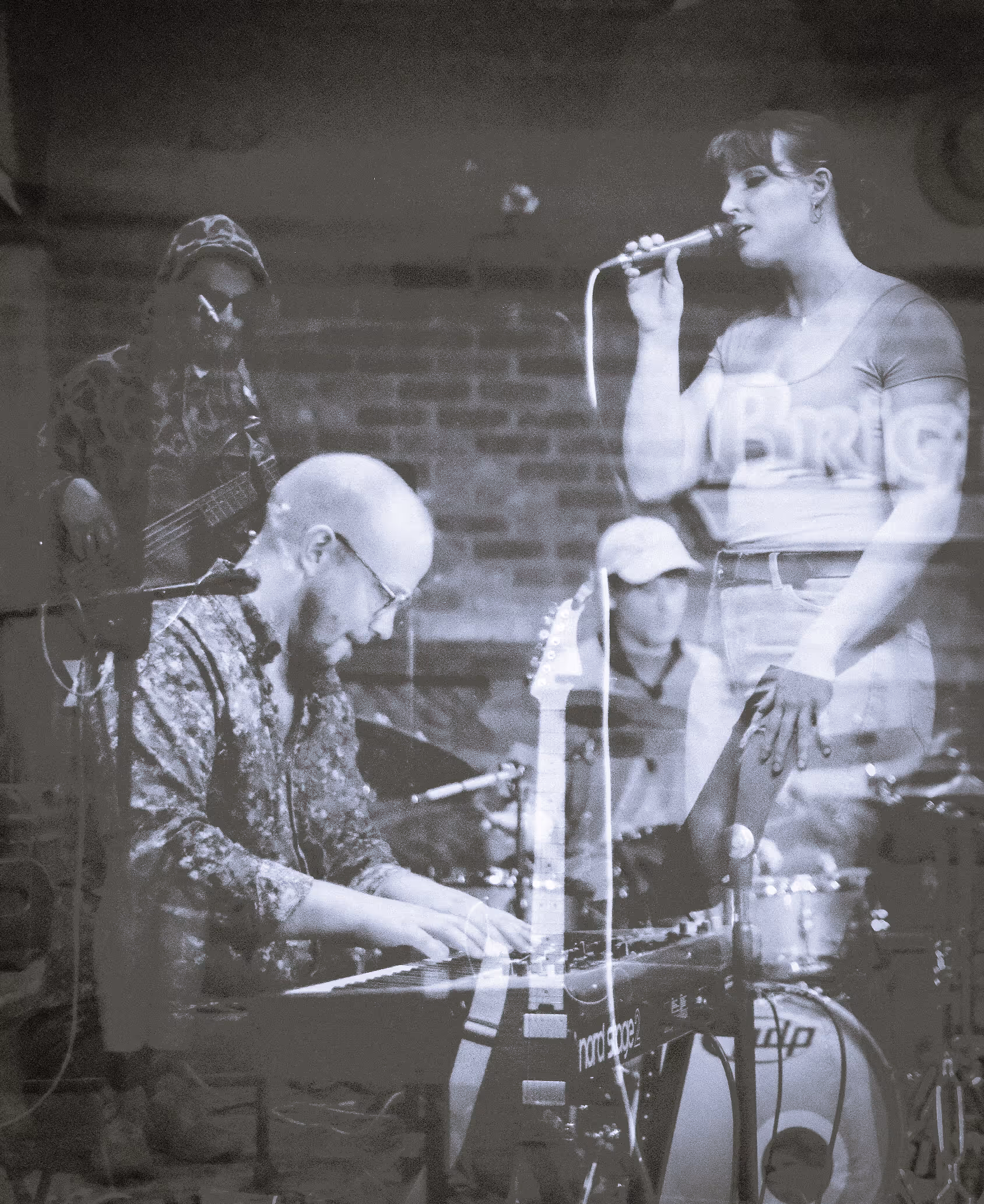 Mishmash overlay of live performance. Key player in front left with singer in upper right.