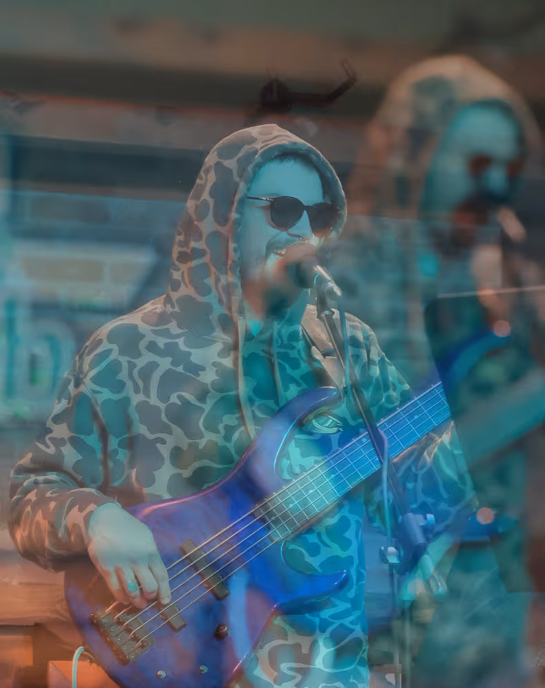 Bass player singing into microphone