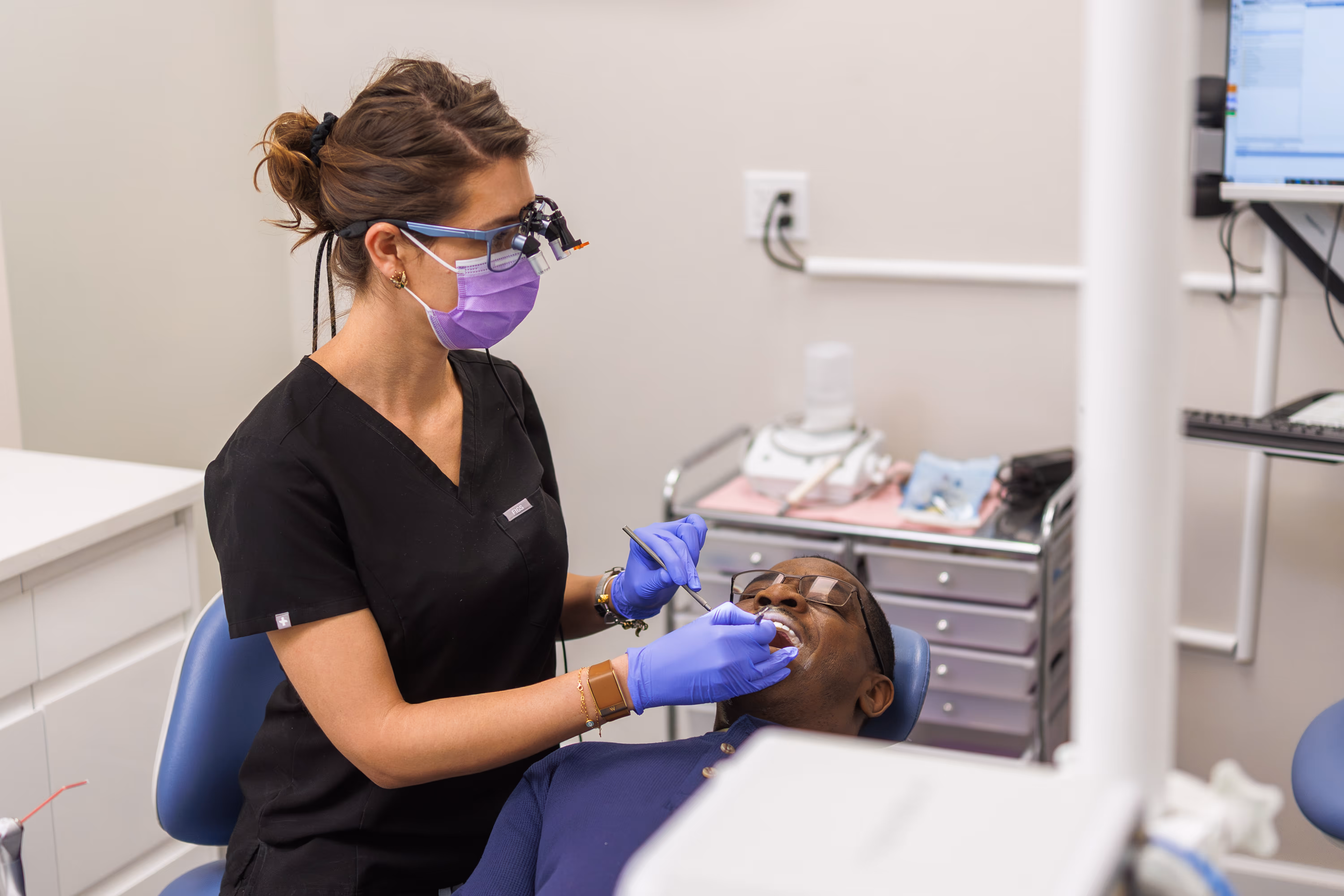 Dentist treating patient with advanced technology at Marvel Dental Clifton NJ