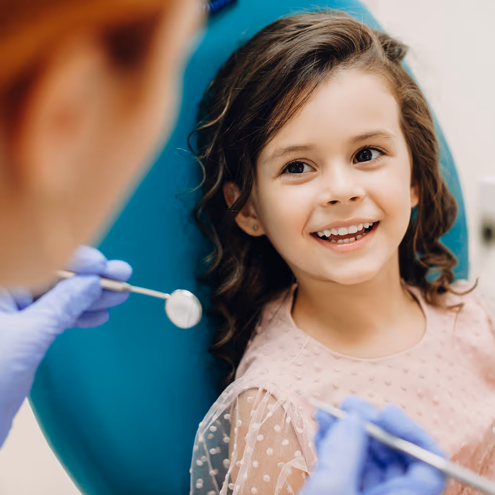 Dentist explaining oral care to a young patient