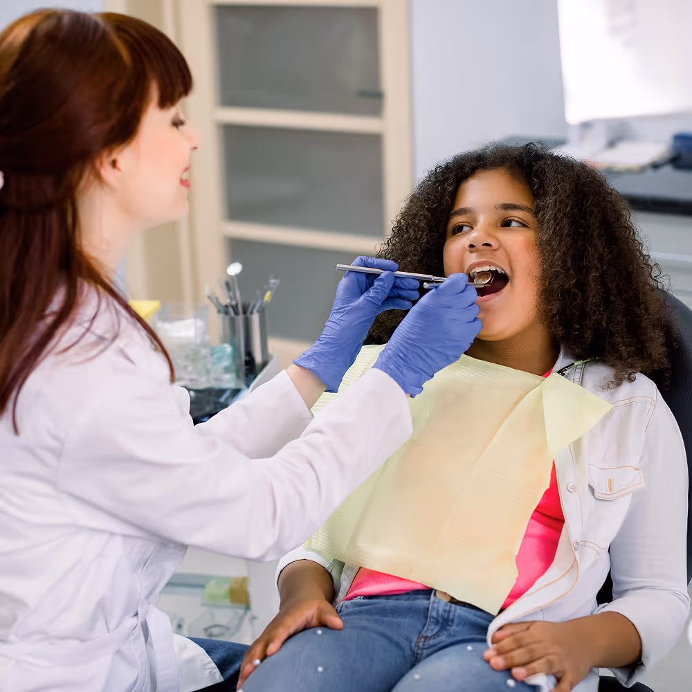 Dentist discussing oral health with a teenage patient