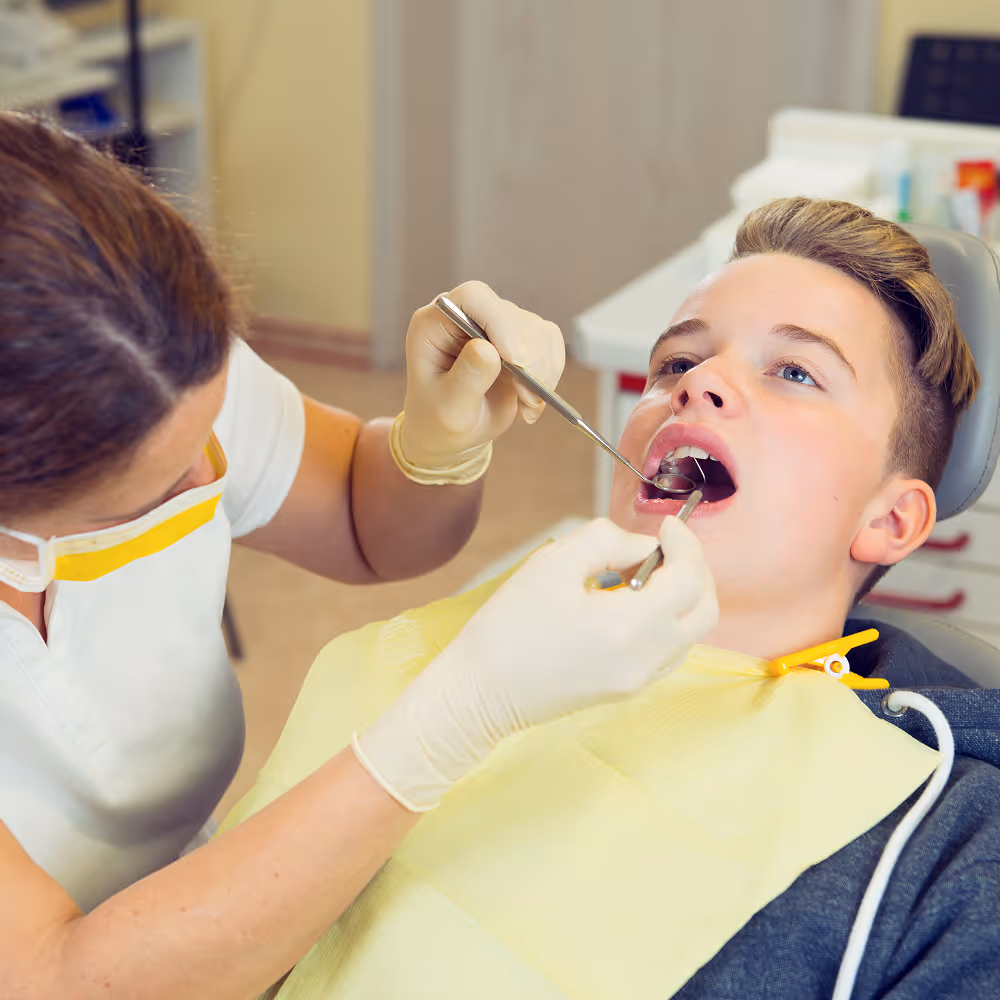 Teen patient receiving a routine dental checkup