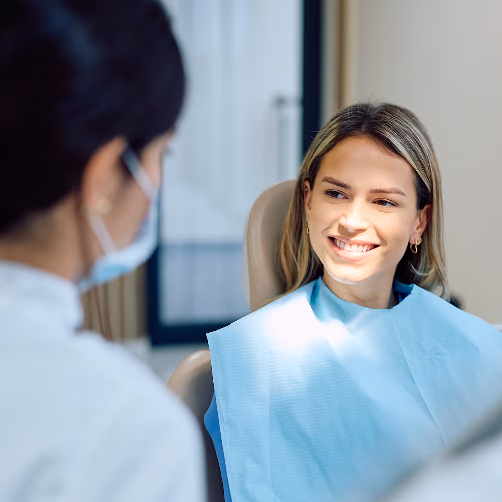 Young adult patient receiving teeth whitening treatment for a brighter smile