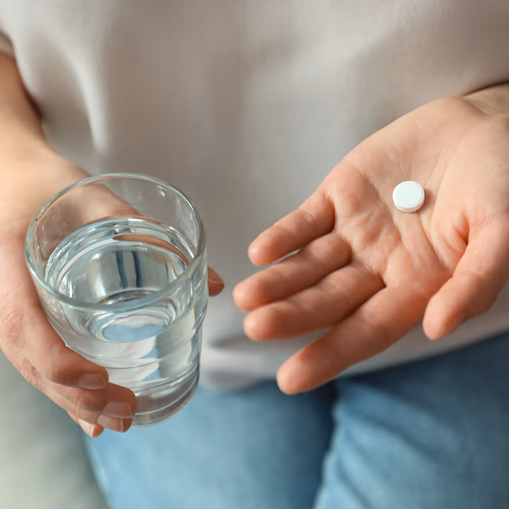 Patient taking oral sedation pill before dental procedure to reduce anxiety and stay calm