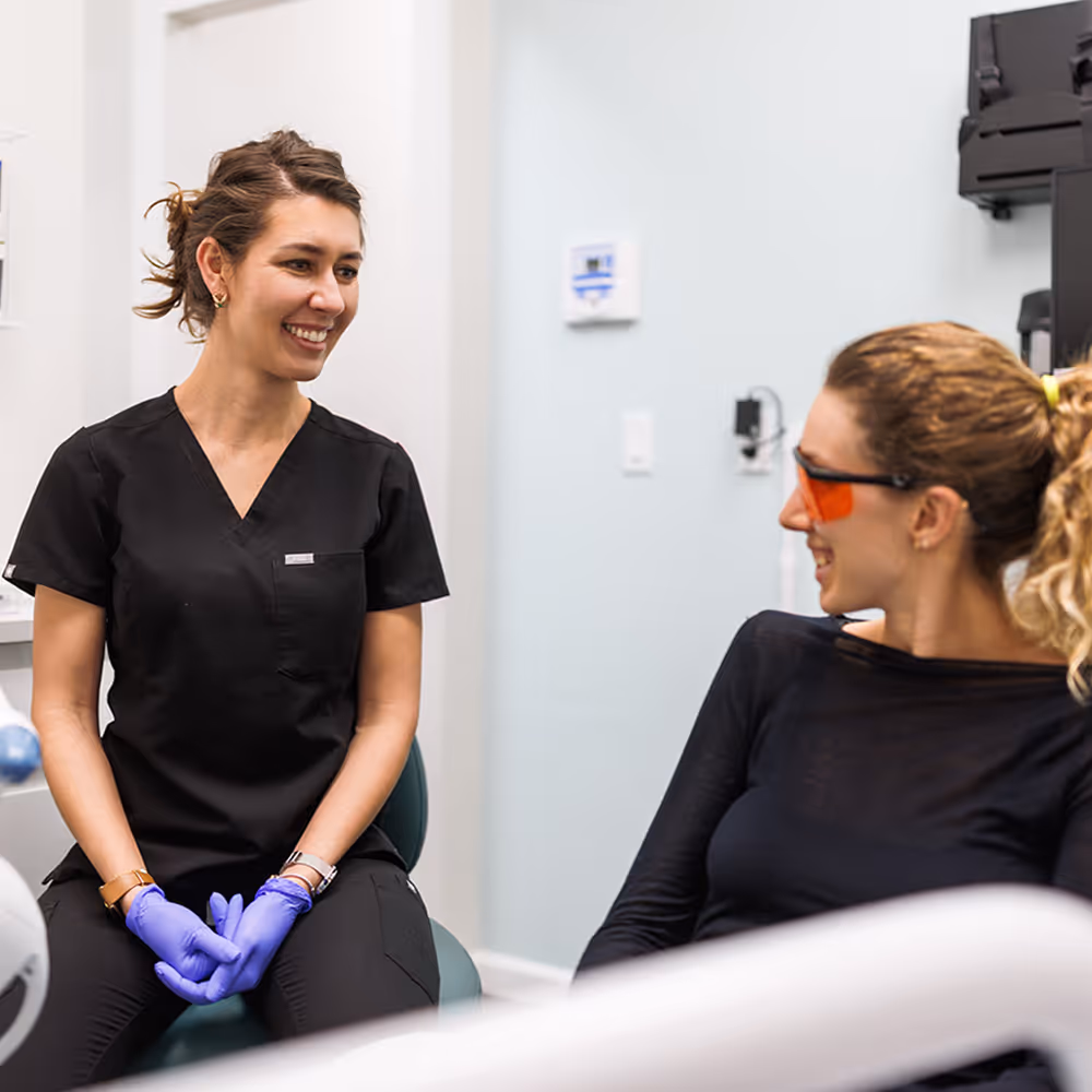 Dentist wearing gloves providing careful and comfortable treatment to a patient