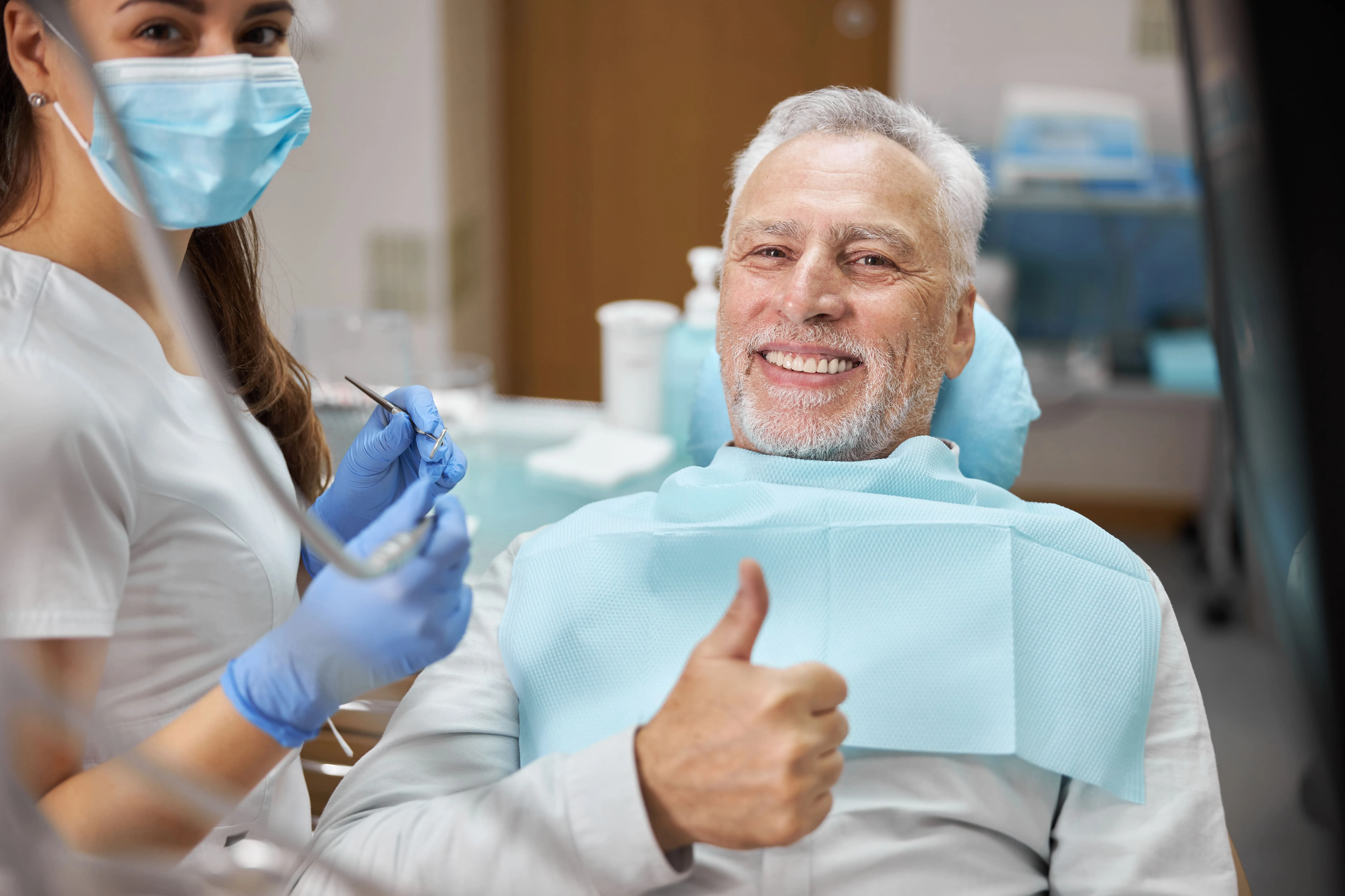 Patient giving a thumbs-up during a dental visit at Marvel Dental in Clifton, NJ