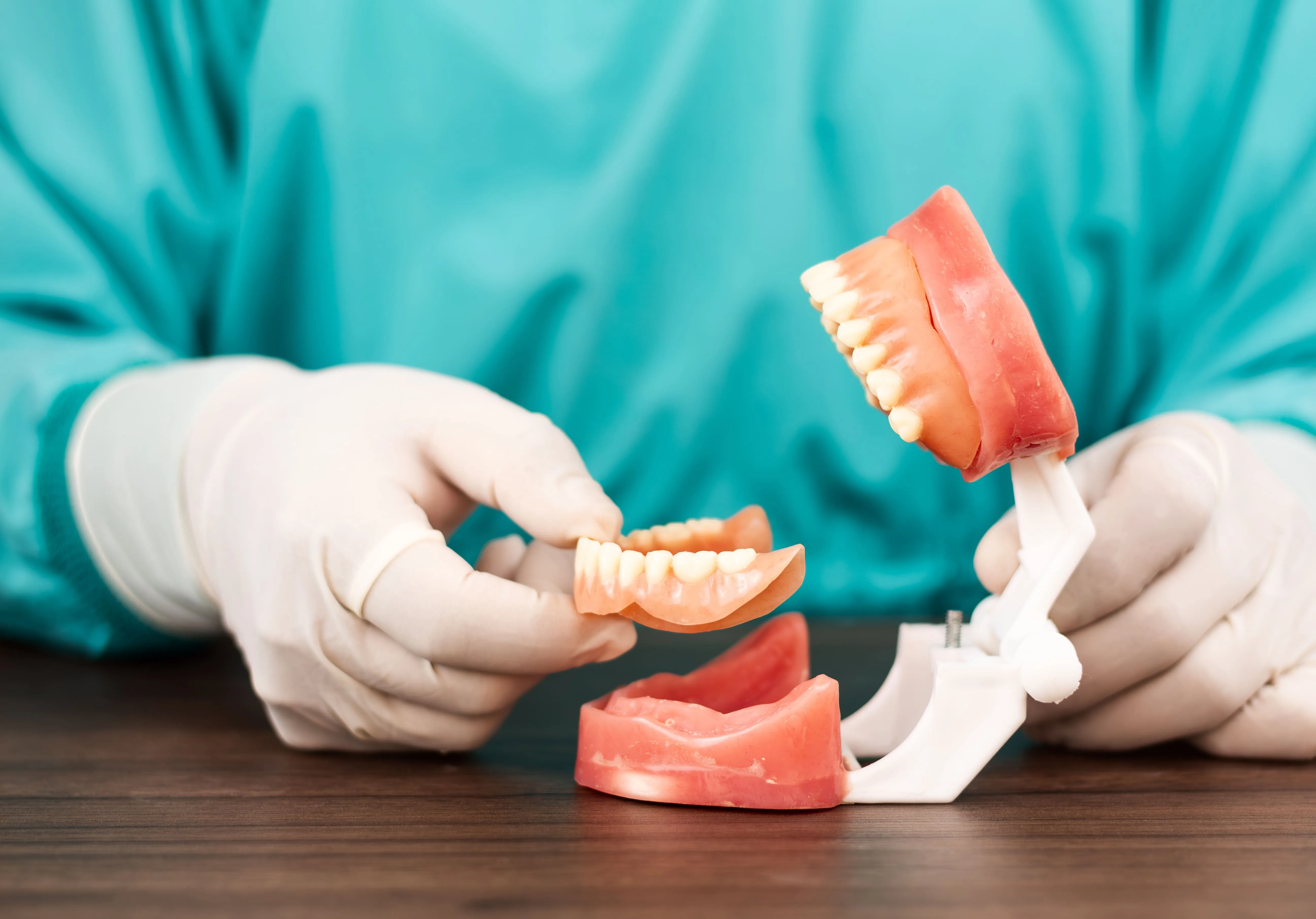 Dental professional demonstrating an implant-supported full-arch restoration near Wayne, NJ
