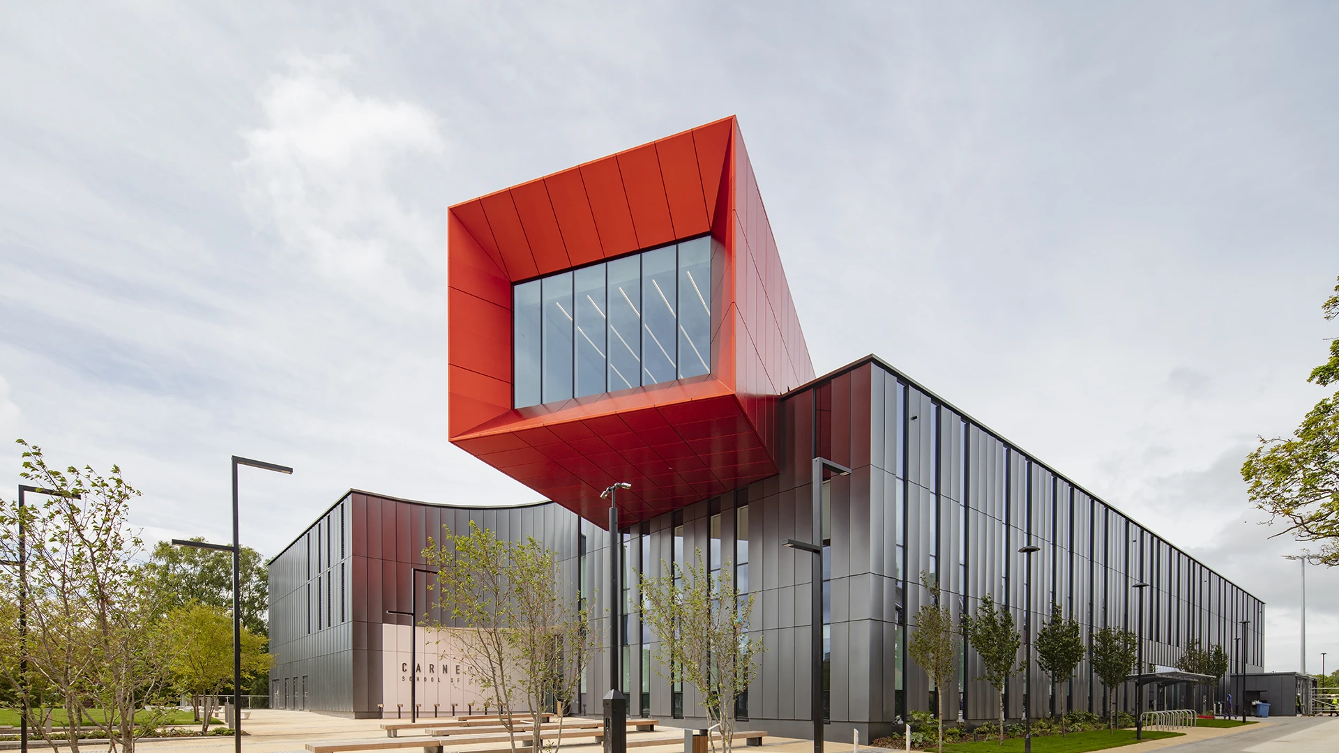 Bright red UnAtex anodised aluminium rainscreen façade on the Carnegie School of Sport at Leeds Beckett University