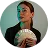 Woman holding and fanning a stack of U.S. dollar bills with a confident expression.