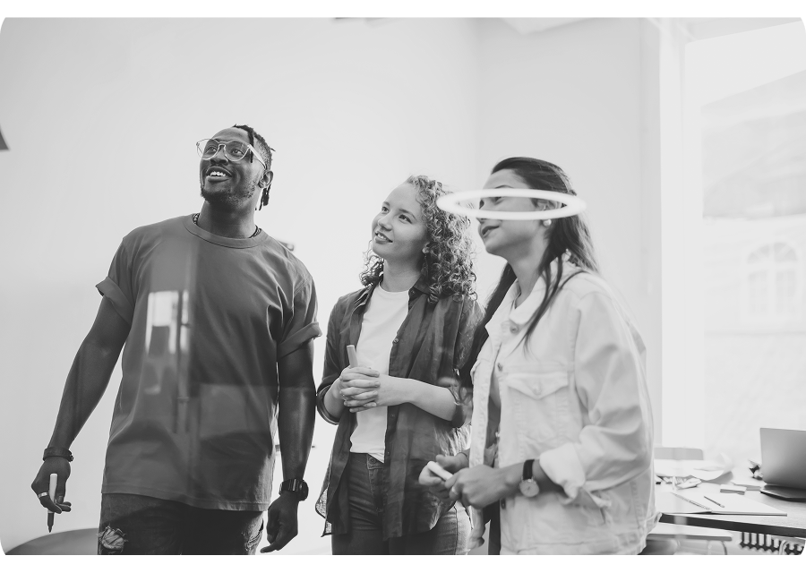 One boy helping another boy up from the ground on a soccer field, showing teamwork and sportsmanship.