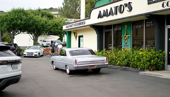 Finished vehicle leaving the Amato's Auto Body storefront after pickup