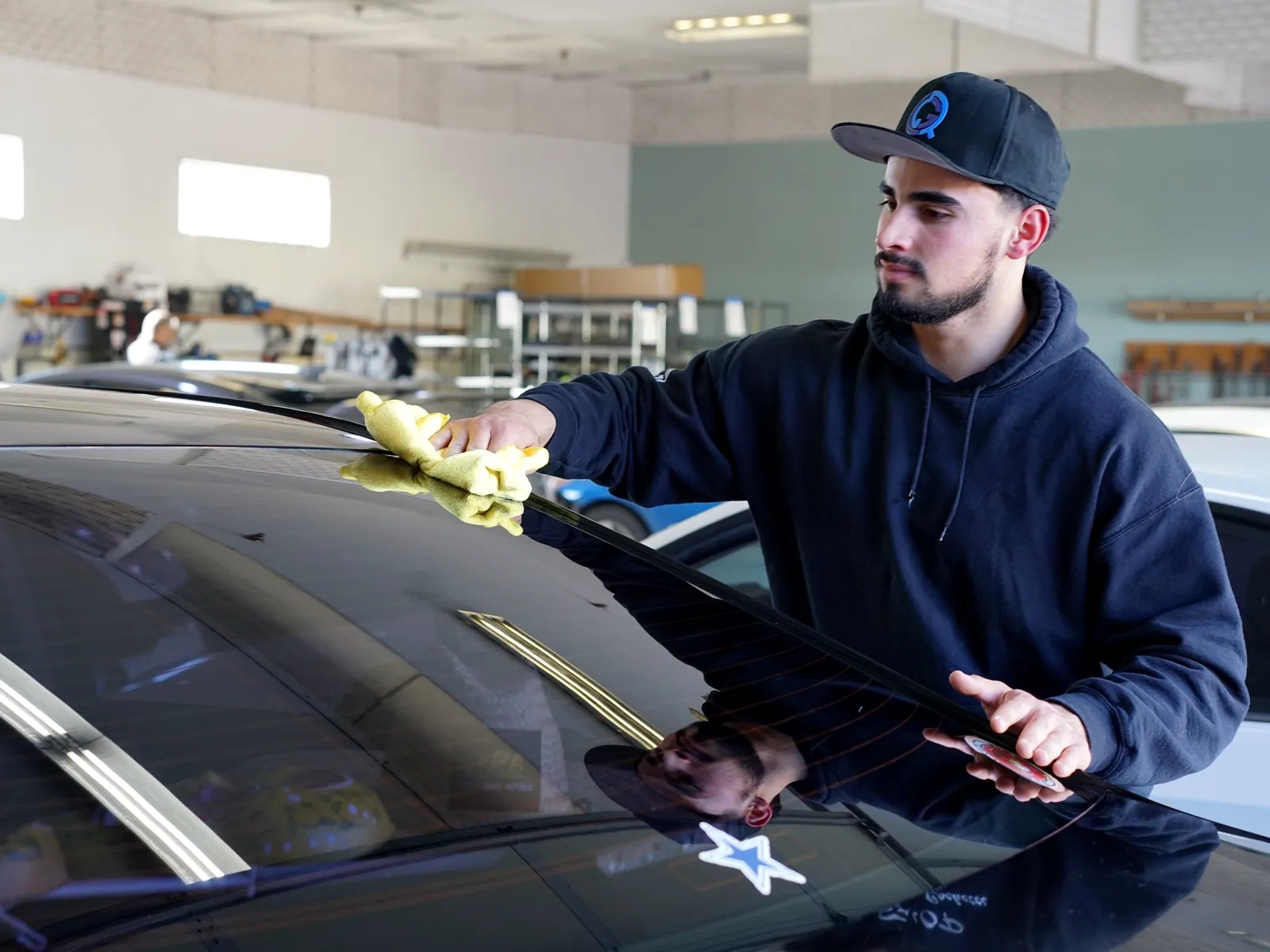 Technician masking a panel during a repair backed by Amato's lifetime warranty