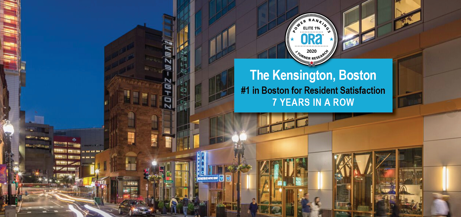 Nighttime view of The Kensington property development in Boston, with ORA banner: "#1 for Resident Satisfaction, 7 Years in a Row, Elite 1% Power Ranking."