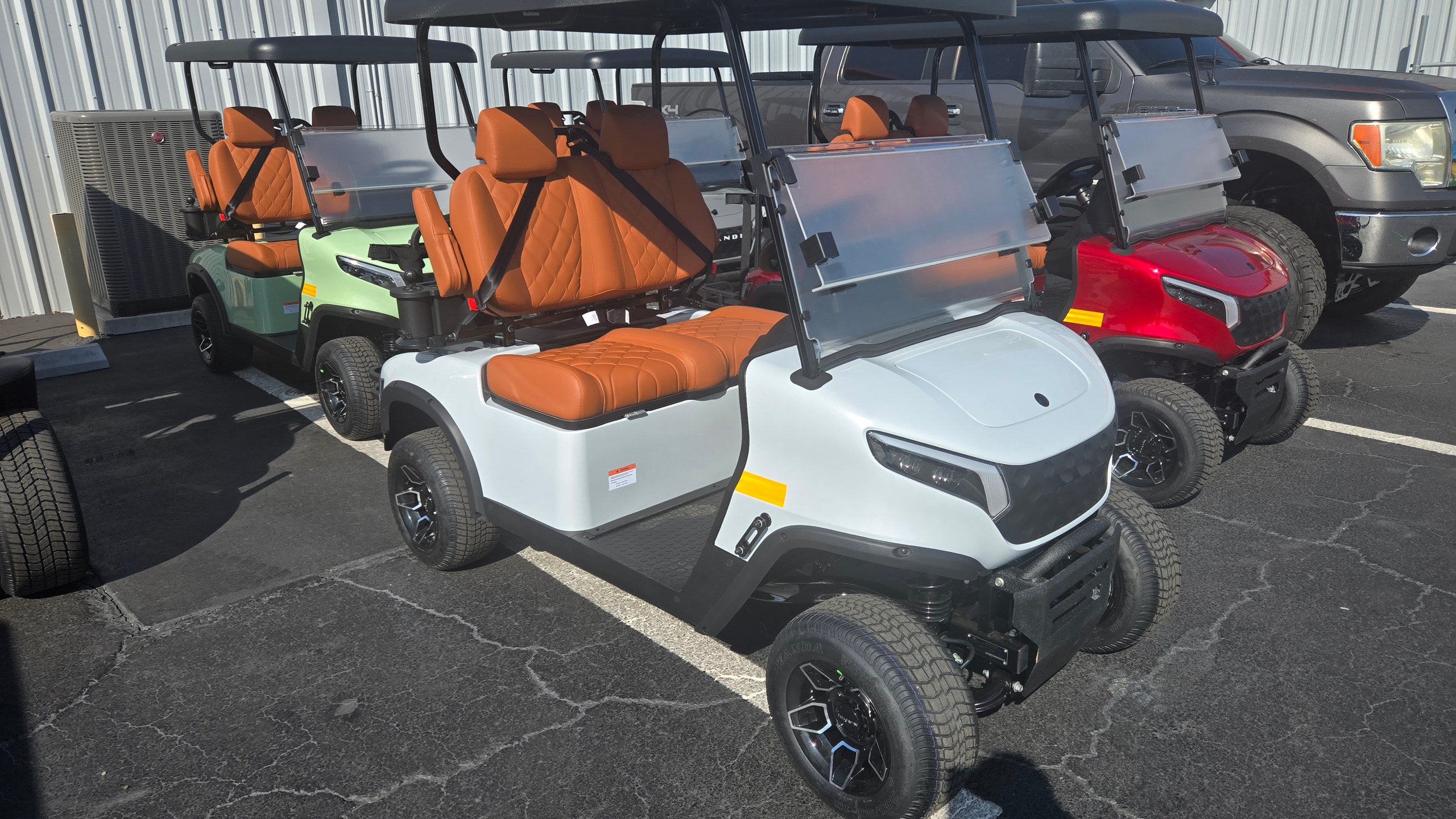 New golf carts and LSVs lined up at a dealer ready for shipping