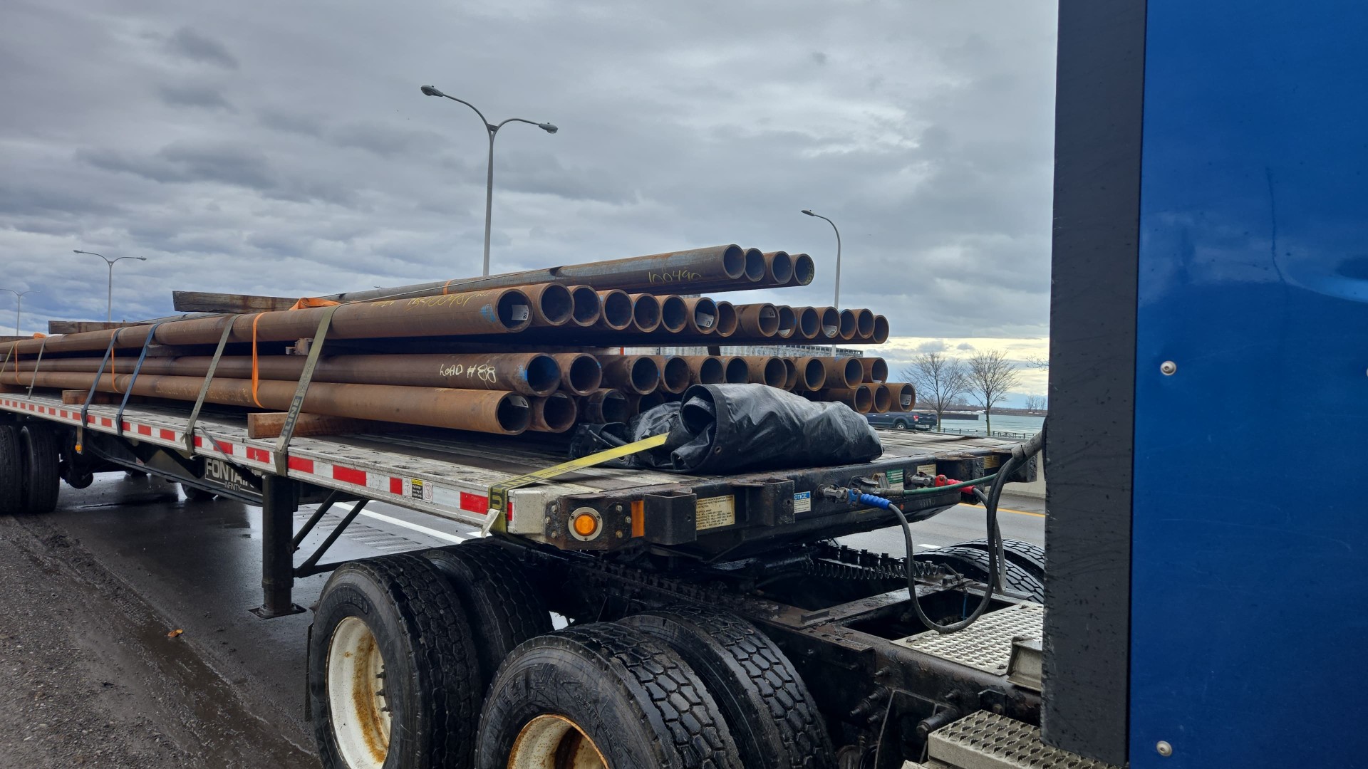 Flatbed load of drill pipe moving between the US and Canada