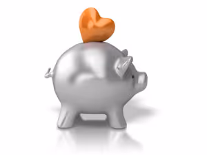 Silver piggy bank with an orange heart on its back on a white background.