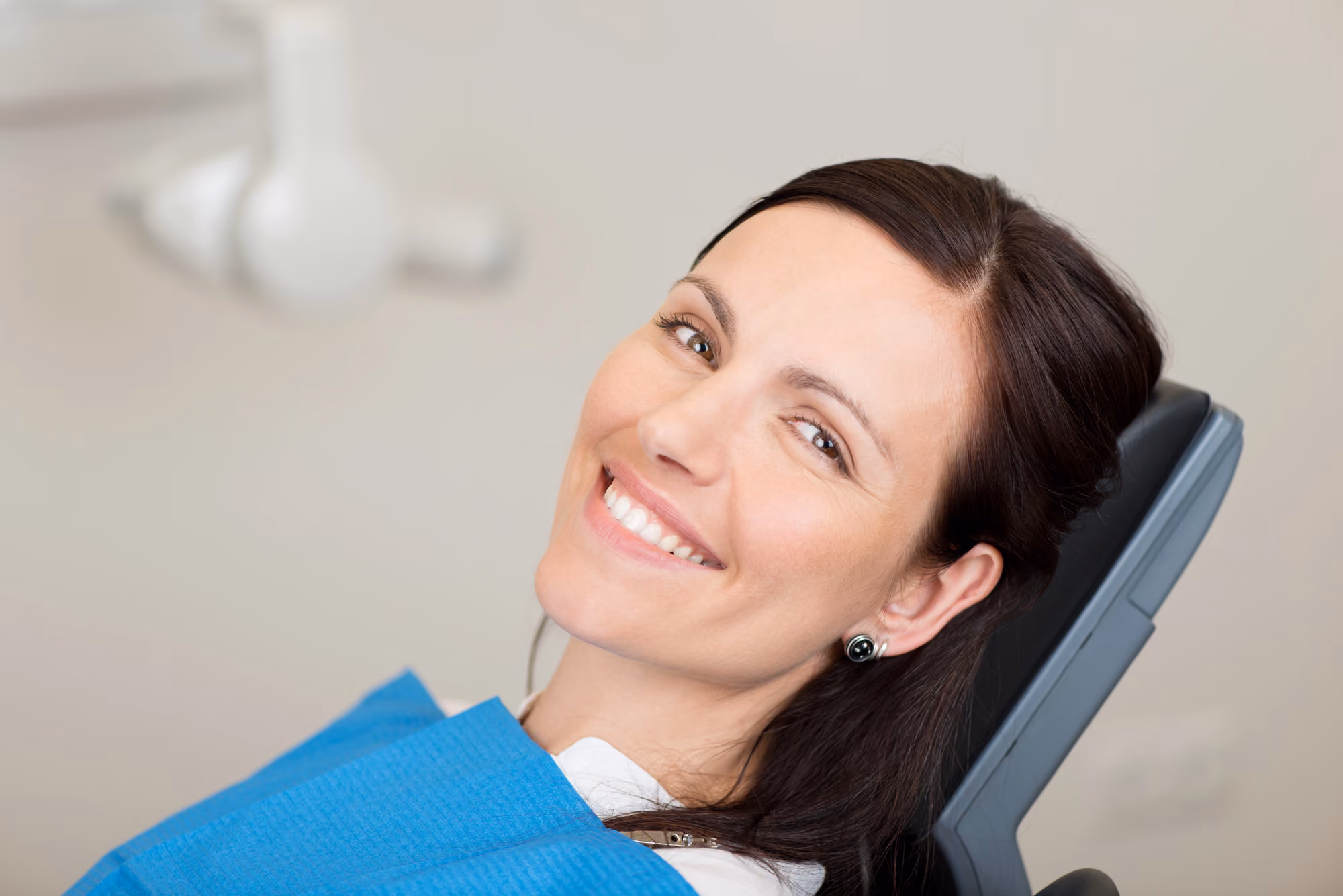 Happy patient seated comfortably in a dental chair during a routine visit.