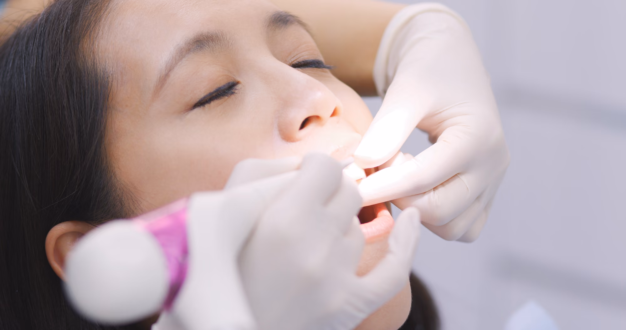 Child receiving a gentle dental examination during a pediatric dental visit.